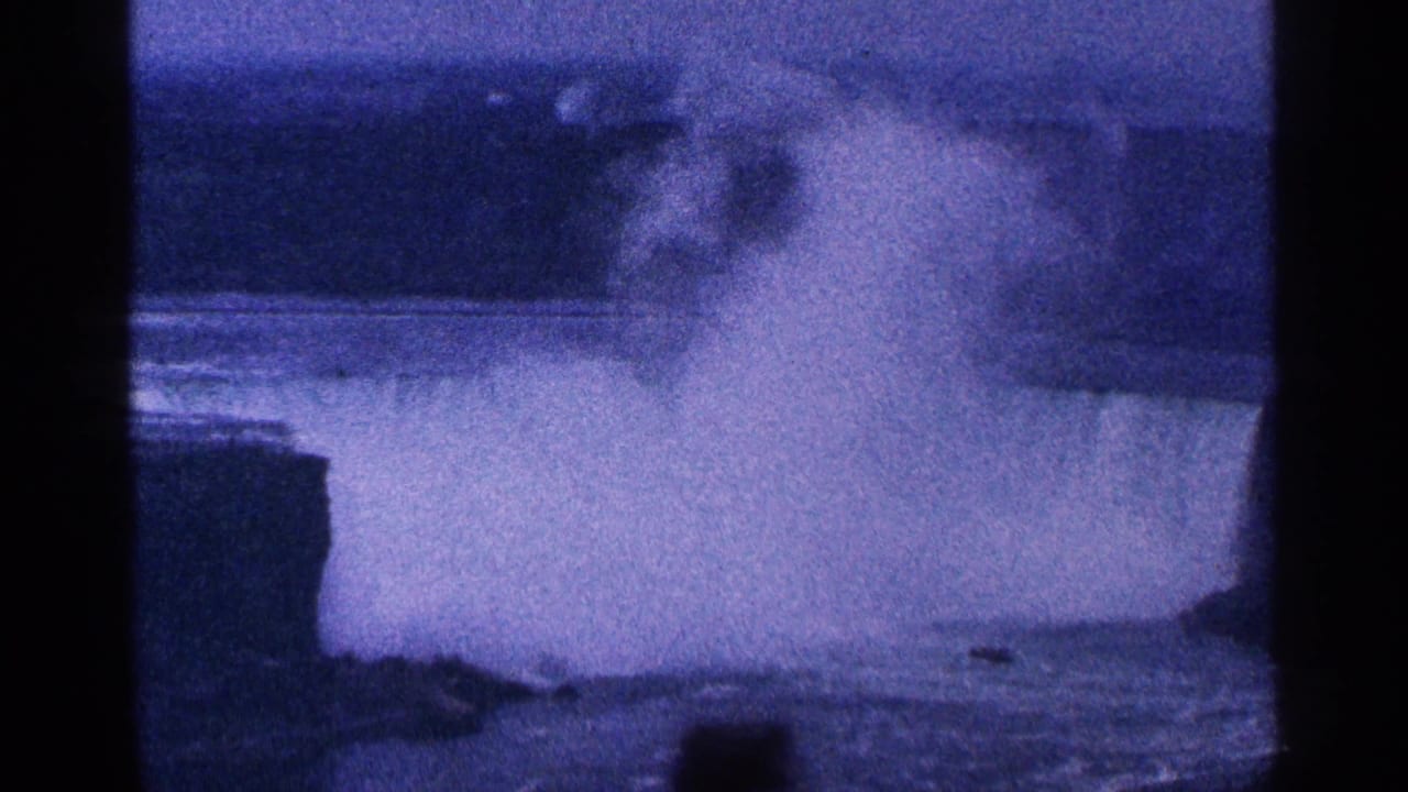 Wide view of mist from the falls with dark film borders and blue-purple color cast.