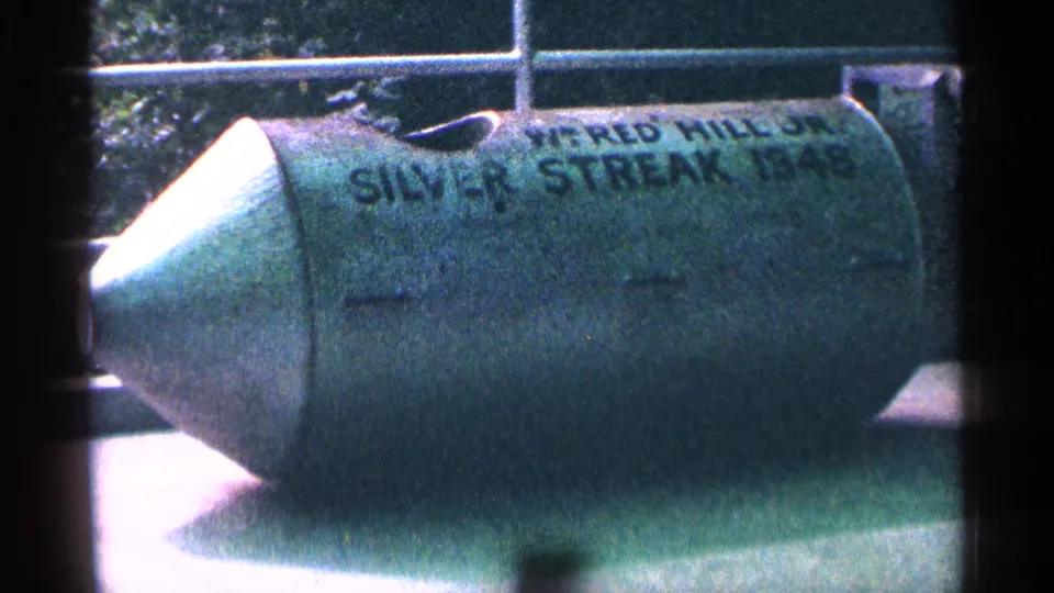 Side view of a green Silver Streak stunt barrel in 1964 Niagara Falls footage, with painted lettering partly visible.