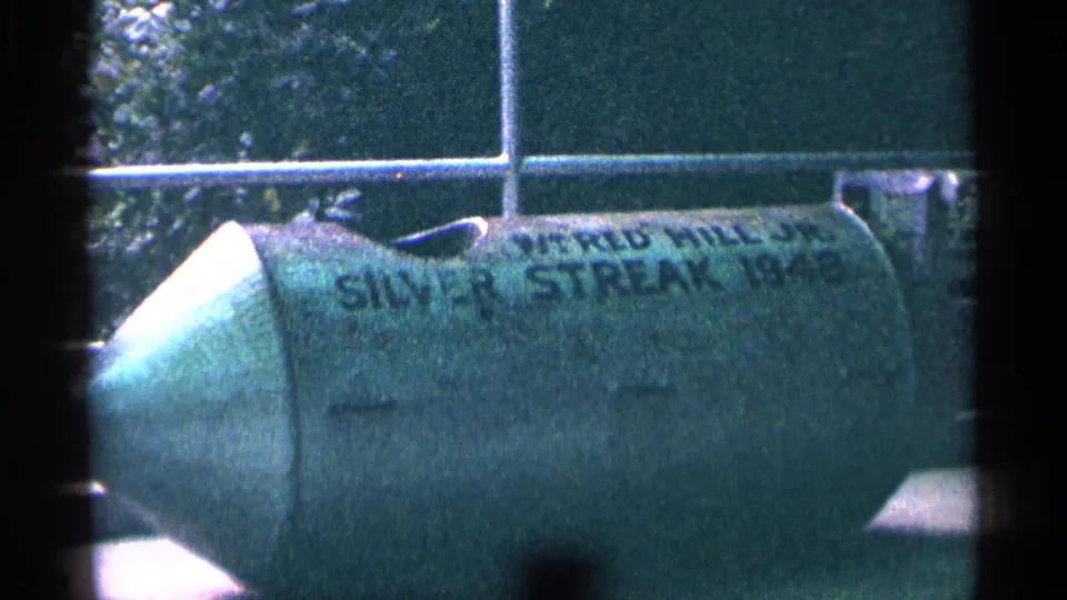 Close 8mm frame of the green Silver Streak stunt barrel at Niagara Falls, with W. Red Hill Jr text partly legible.