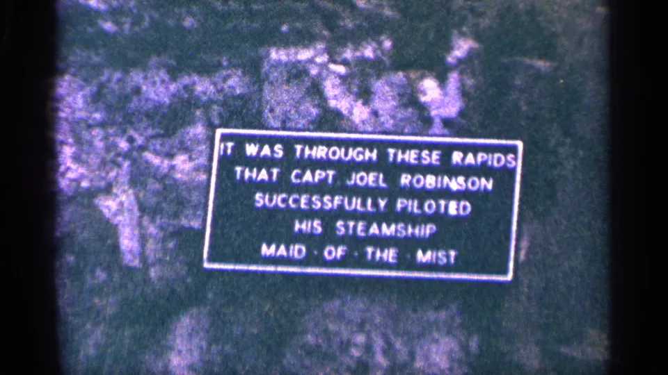 1964 Niagara Falls frame showing the Capt. Joel Robinson and Maid of the Mist exhibit sign on a rock-like display surface.