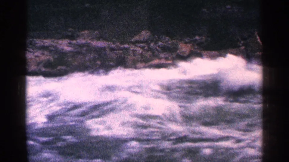 1964 Niagara Falls Canada home-movie frame of turbulent rapids and dark rocks in grainy color 8mm.