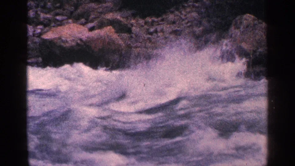The final 1964 8mm frame shows foaming water sweeping past rocks at Niagara Falls, Canada, with visible grain and color fading.