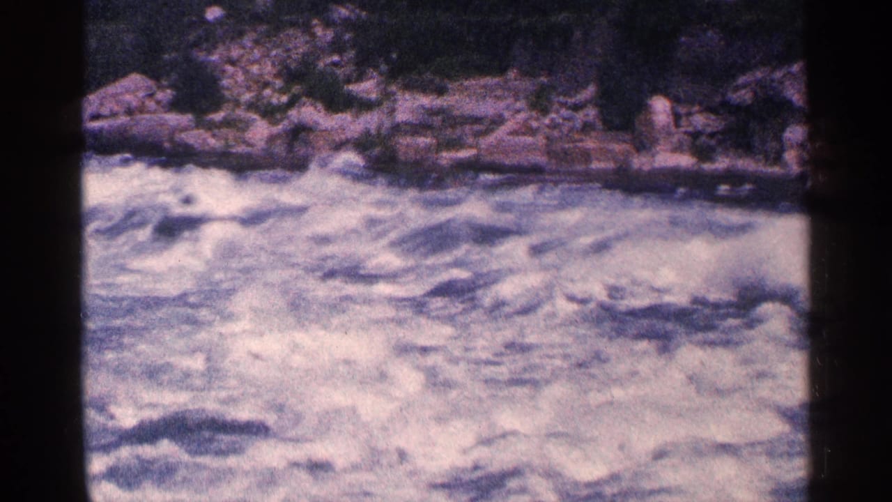 Foaming whitewater rapids churn through a rocky section of the Niagara Falls area in 1964 home-movie footage.