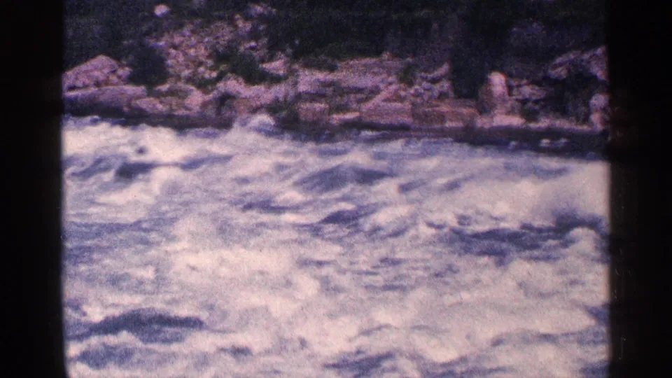 Foaming whitewater rapids churn through a rocky section of the Niagara Falls area in 1964 home-movie footage.