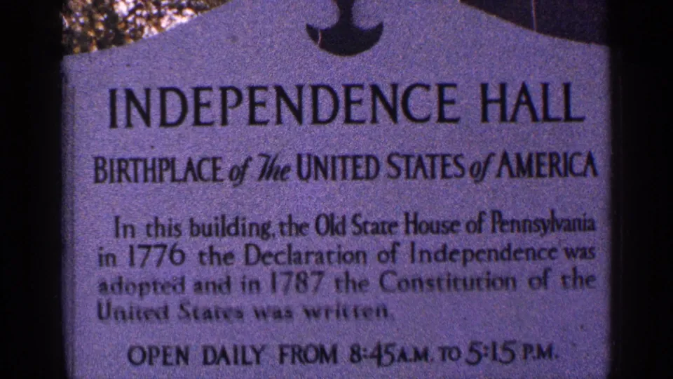 Close 1964 8mm view of the Independence Hall marker describing the building's historical role and posted visiting hours.
