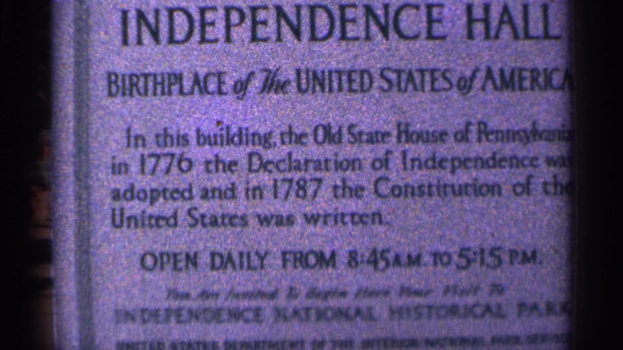 1964 Pennsylvania 8mm frame showing a close-up Independence Hall placard identifying the site as the birthplace of the United States.
