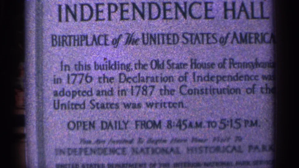 1964 Pennsylvania 8mm frame showing a close-up Independence Hall placard identifying the site as the birthplace of the United States.