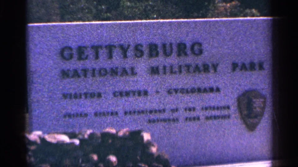 Clearer 8mm frame of the Gettysburg National Military Park visitor center sign and emblem.
