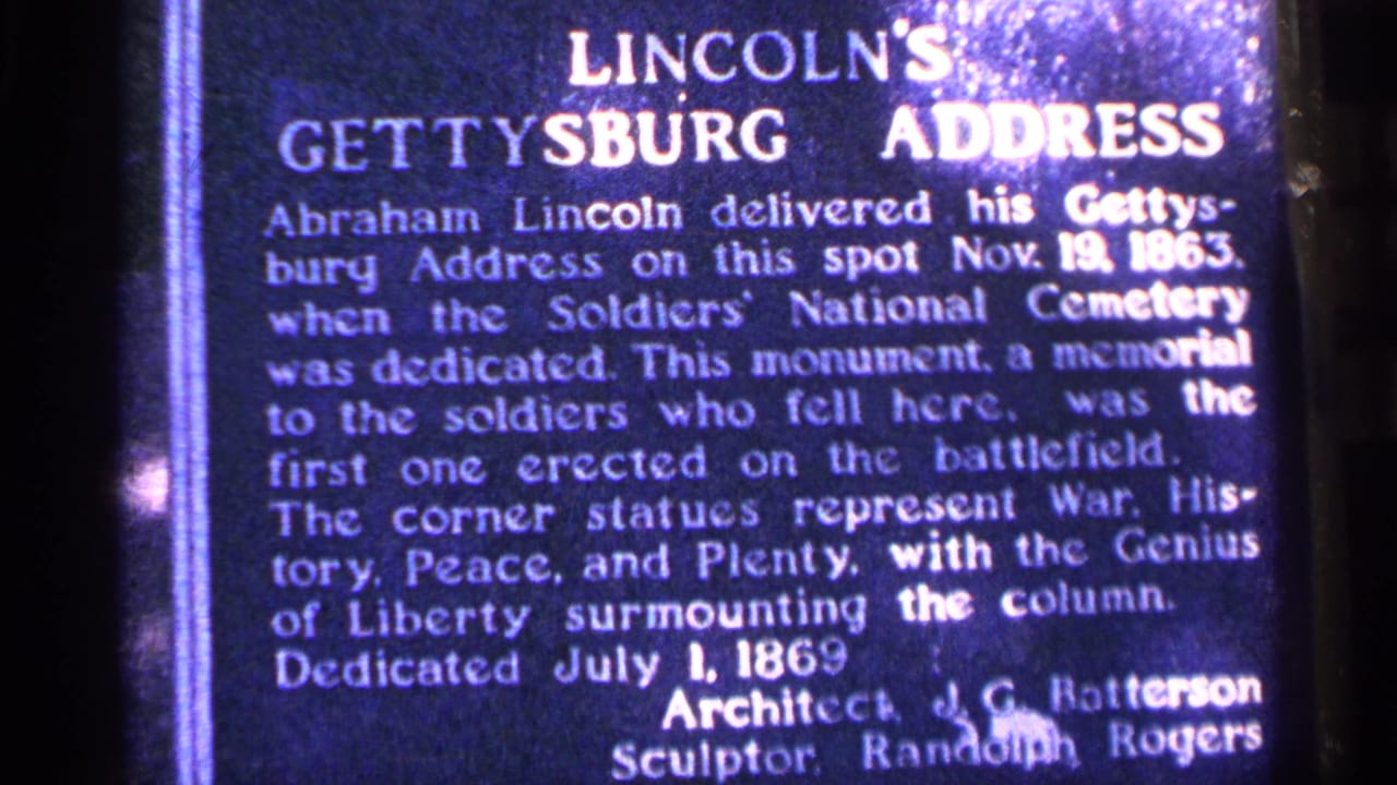 Close view of a Gettysburg Address monument plaque with white lettering on a dark surface.