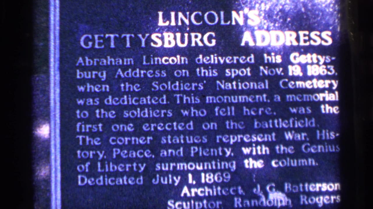 Close-up of the same Gettysburg Address plaque with dense white text and dark film edges.
