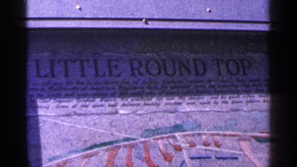 1964 Pennsylvania 8mm close view of a Little Round Top sign, with large carved lettering and red map-like linework below.