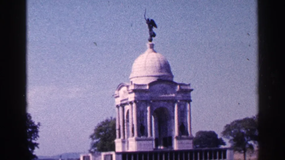 Visitor-shot 1964 Pennsylvania view of a white domed memorial structure with columns, trees, and clear sky.