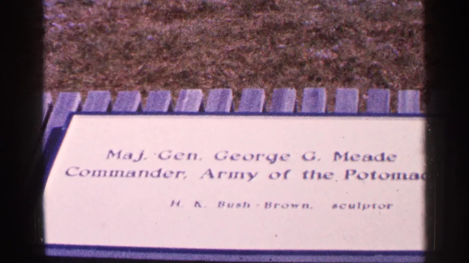 1964 8mm frame showing a slightly lower close-up of the Maj. Gen. George G. Meade plaque, with the inscription and H. K. Bush-Brown credit visible.