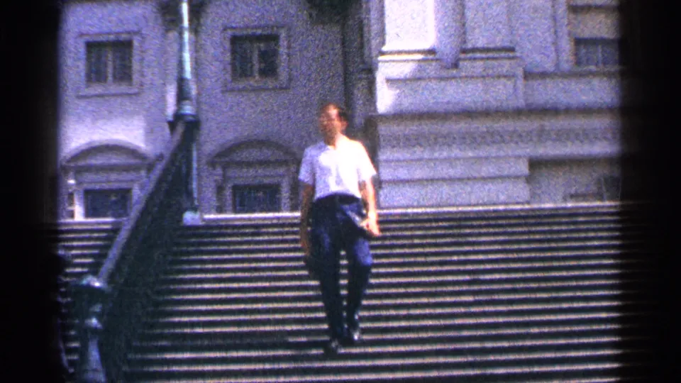 Near the end of the shot, the man descends closer to camera on the broad 1964 Washington DC stairway.