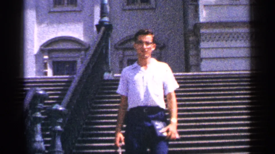 The man continues down the U.S. Capitol steps in Washington, DC, with the handheld 8mm camera keeping him centered.