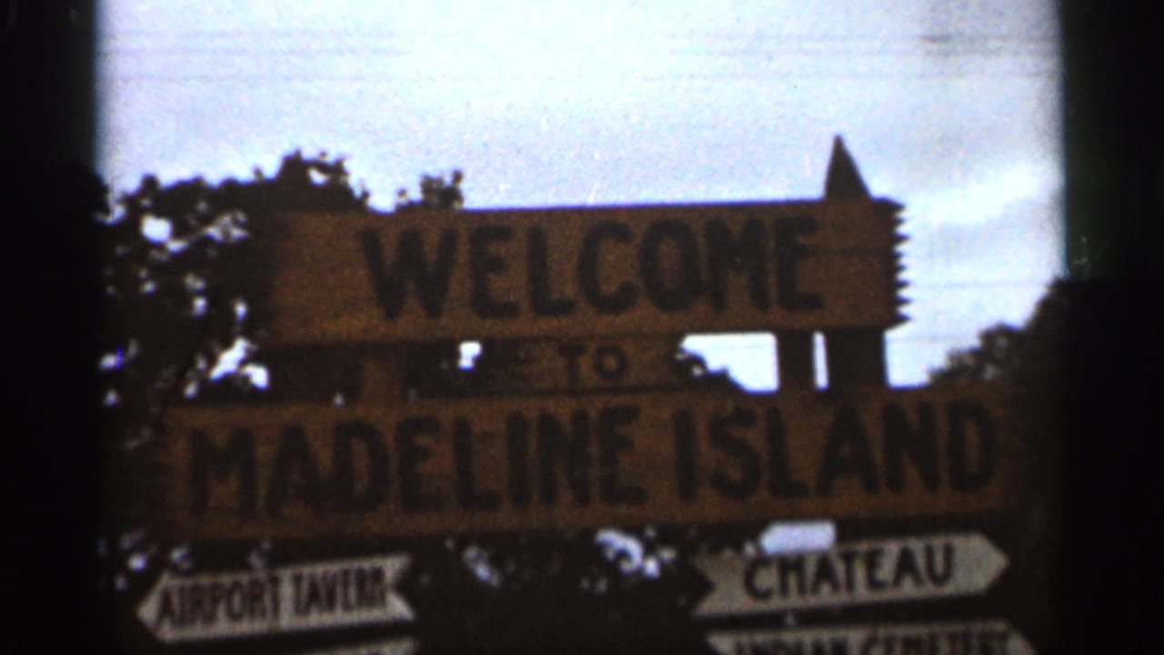 Closer view of the Madeline Island welcome sign and directional arrows.