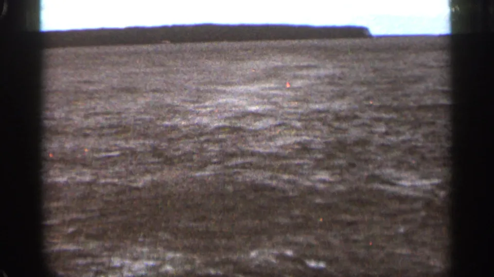 1965 Duluth metadata context shows choppy open water under a pale sky with visible 8mm frame borders.