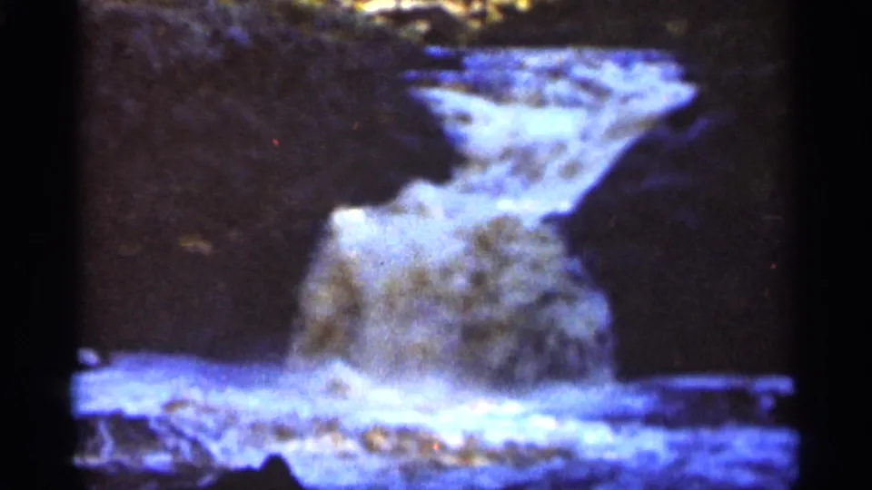The Duluth waterfall sequence ends on water spilling from a rock ledge into a white, turbulent streambed.