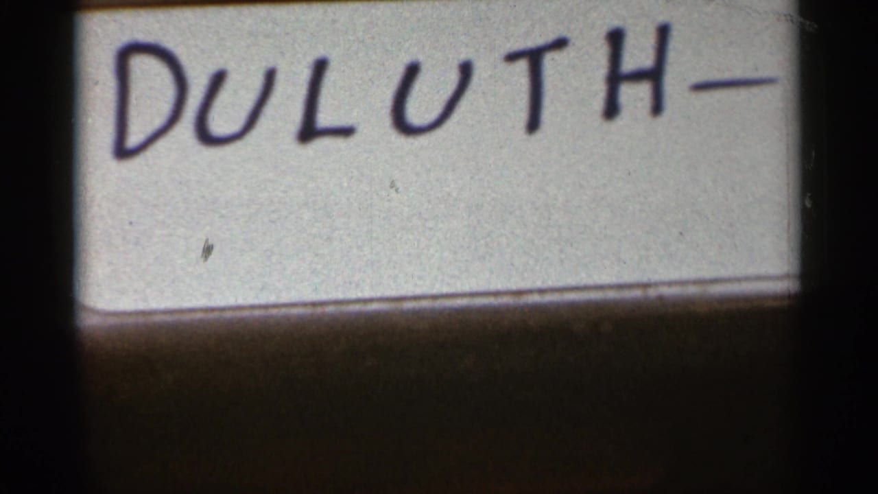 Handwritten Duluth label on a white surface with dark film borders.