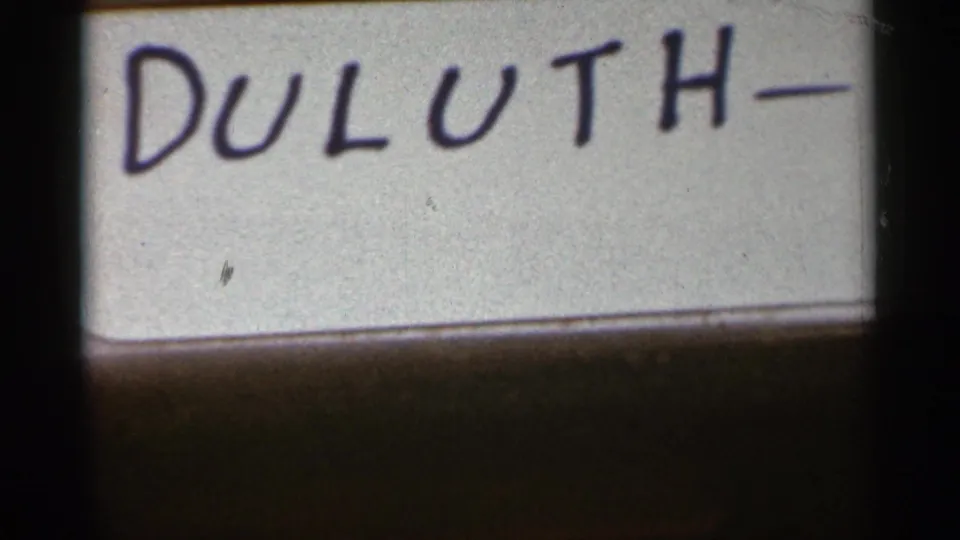 1965 Duluth home-movie title card with handwritten dark lettering on a white surface.