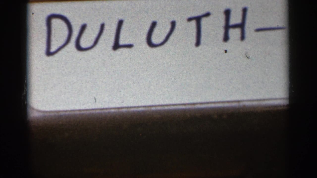 Second view of the handwritten Duluth label on a white surface.