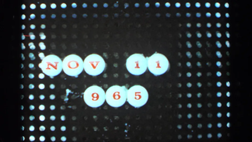 1960s home-movie pegboard title frame with white markers and red NOV 11 965 date text.