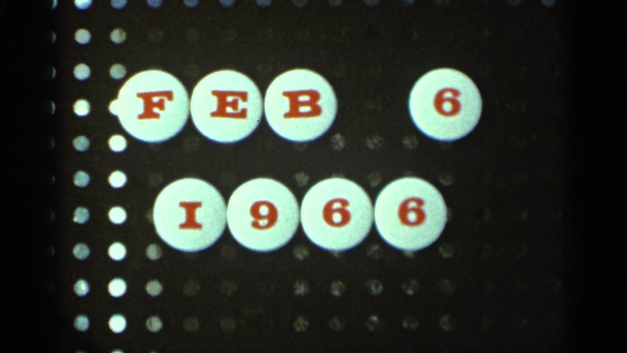 Close-up of a date card reading FEB 6 1966 with perforation edges visible.