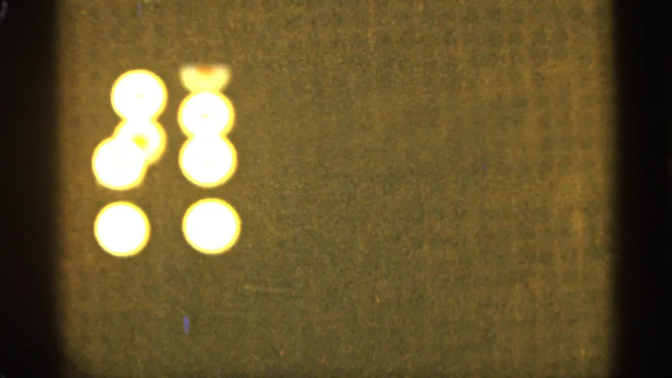 Several bright yellow-white orbs cluster in two loose vertical columns on a dark, grainy 8mm frame associated with Duluth, Minnesota in 1965.