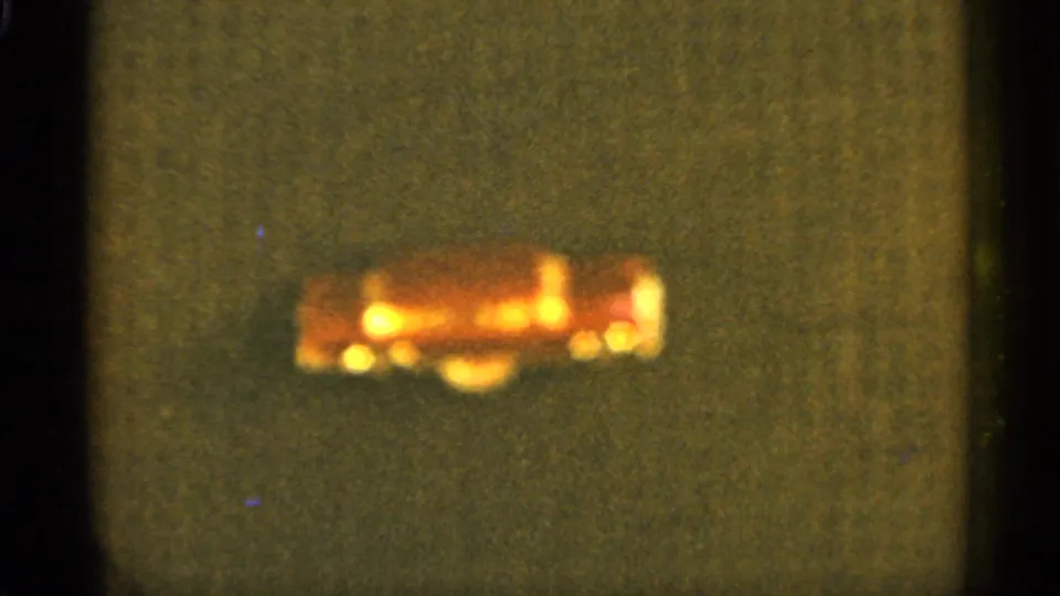 1965 Duluth 8mm frame with a soft red light shape low in the frame and muted green-brown screen texture.