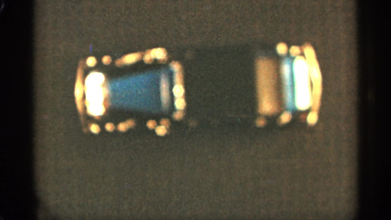 Small blue toy car seen from above on a dark textured surface.
