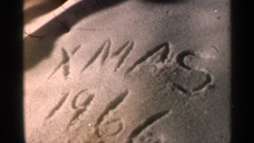 The snow fills the frame with “XMAS 1966” scratched into it, filmed in faded color on 8mm stock.