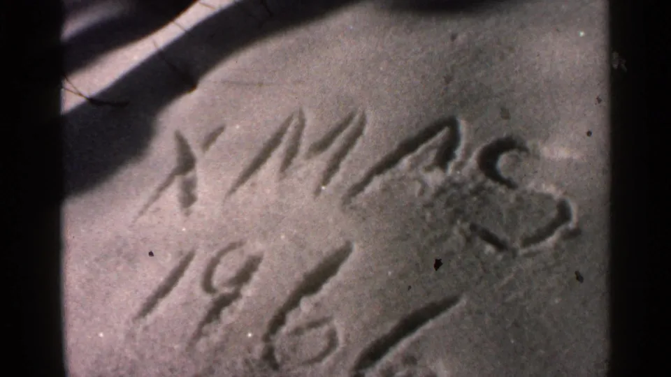 A close 8mm frame shows the “XMAS 1966” snow inscription from a slightly different angle, with grain and dark gate edges visible.