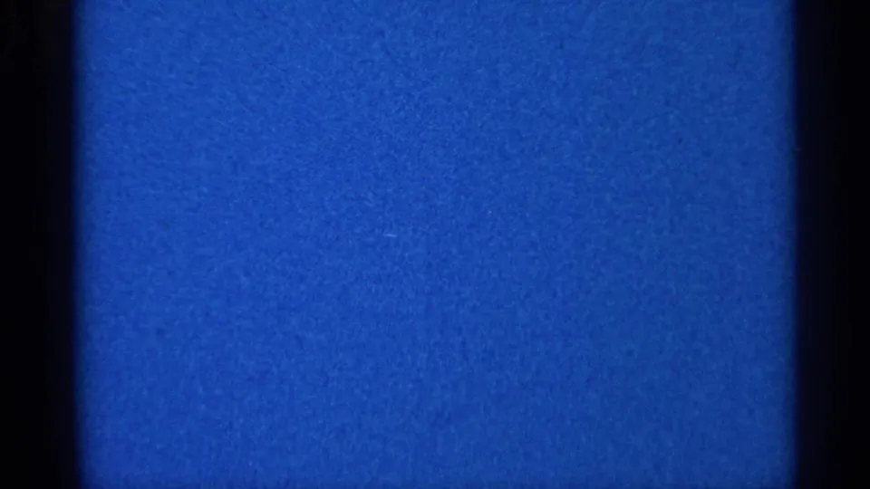 Blue 8mm home-movie frame from the 1966 Eau Claire metadata, with visible grain, dark borders, and slight tonal variation.