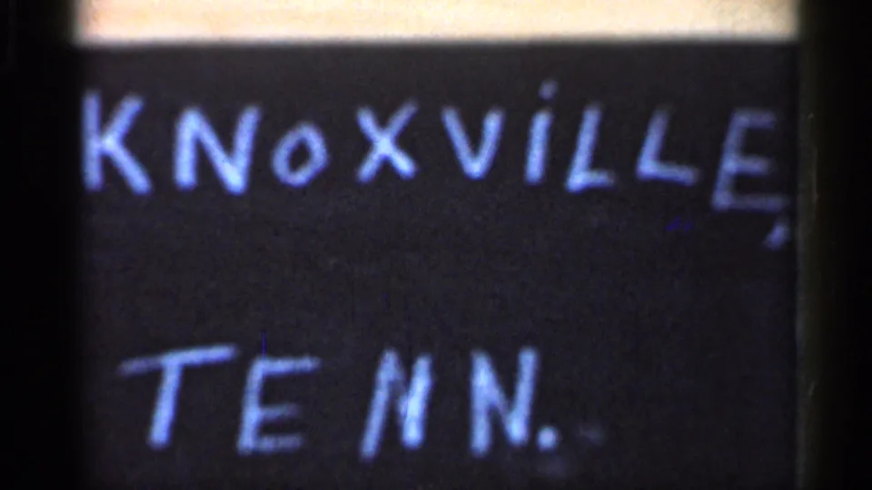 Handwritten Knoxville, Tenn. title card beneath a soft 8mm city-street view from the same short clip.