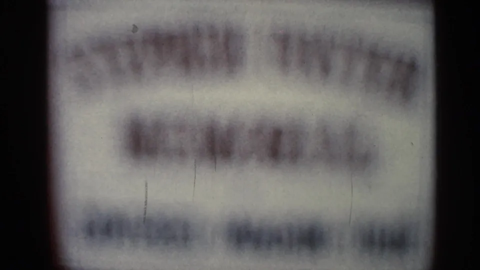 Out-of-focus sign at the start of a 1966 Florida 8mm home movie, with text too blurred to identify.