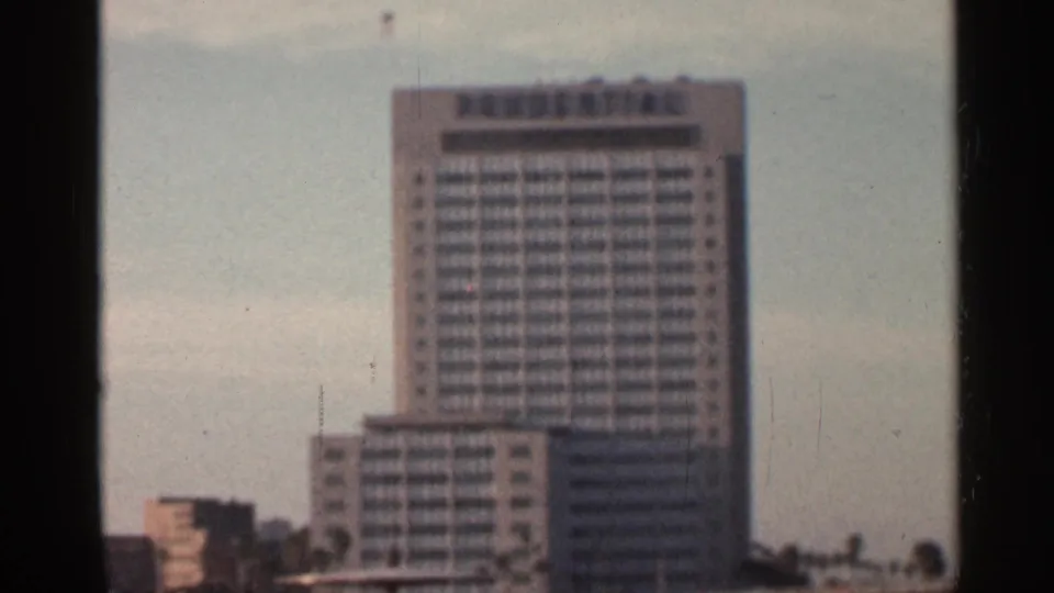 1966 Florida 8mm view of a modern high-rise, with dark film or window edges around the scene.