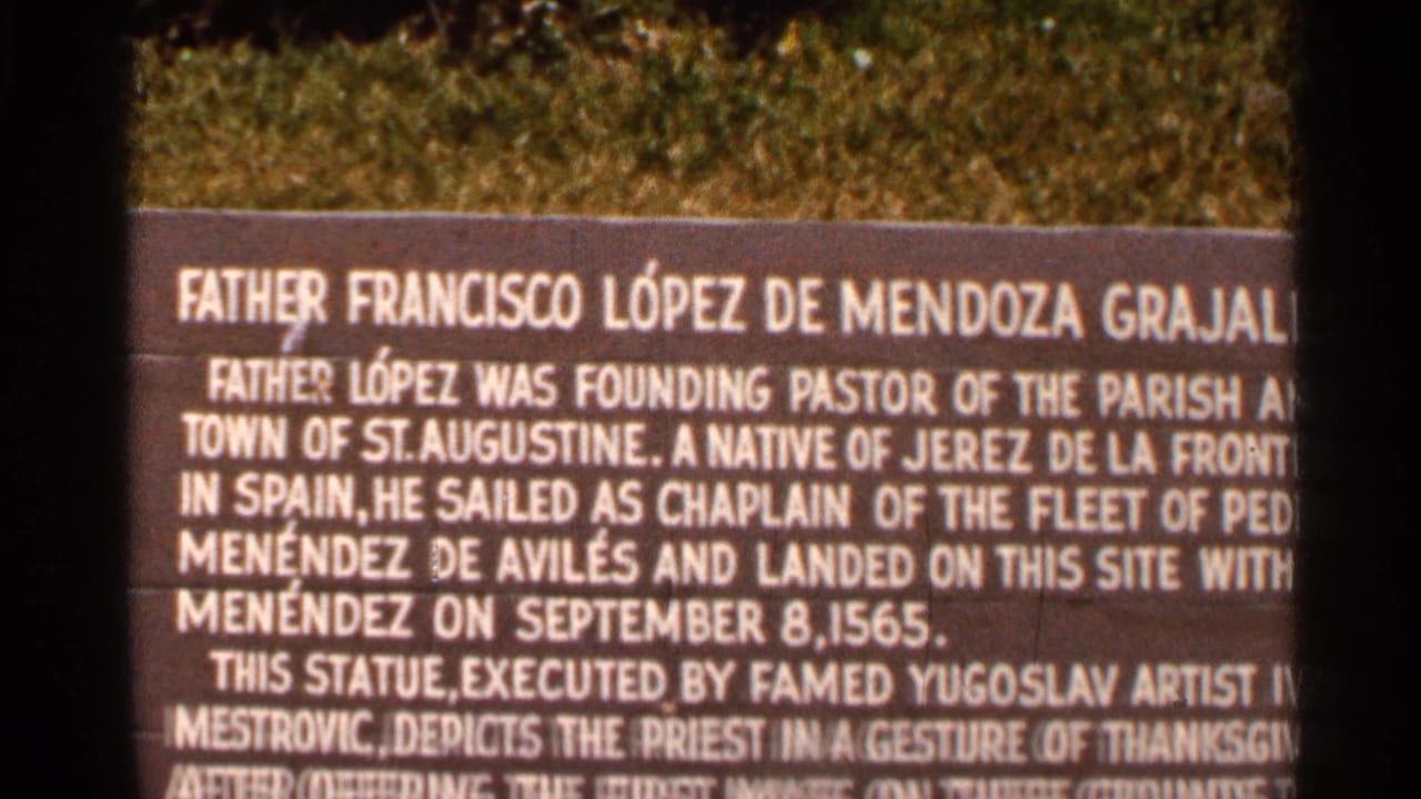 1966 Florida 8mm frame showing a close-up of the Father Francisco Lopez de Mendoza Grajales plaque at Mission of Nombre de Dios.