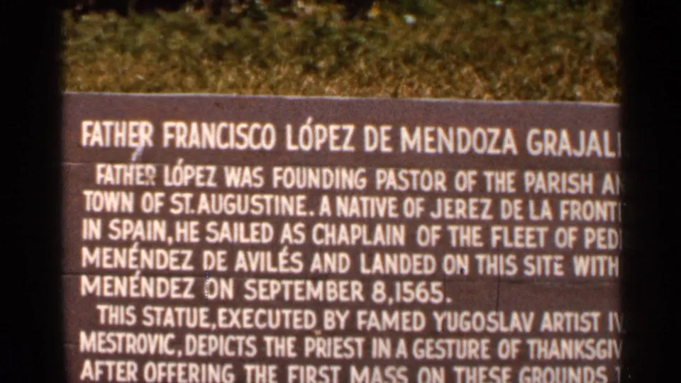 Close 1966 Florida home-movie view of the Father Francisco Lopez plaque, partly obscured by the film frame edge.