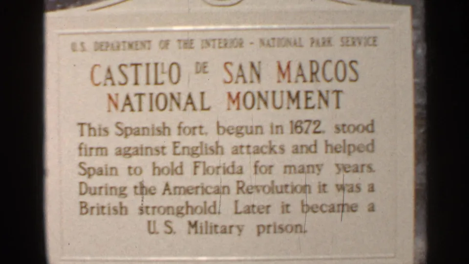 Close 8mm view of the Castillo de San Marcos National Monument plaque describing the Spanish fort and later military prison.