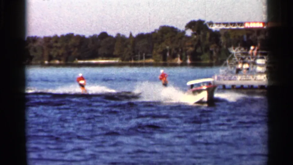 1966 Florida 8mm frame showing two water skiers behind a motorboat, with another boat partly visible along the right edge.