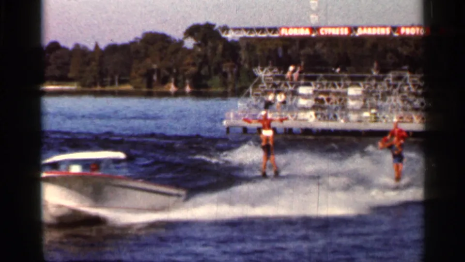 A close pass of the speedboat and two water skiers at Cypress Gardens, captured in soft 1960s 8mm color.