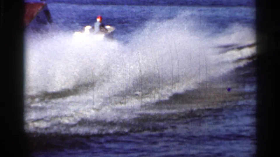 Close pass from a show boat at the 1966 Florida water ski performance, with large spray obscuring much of the lake.