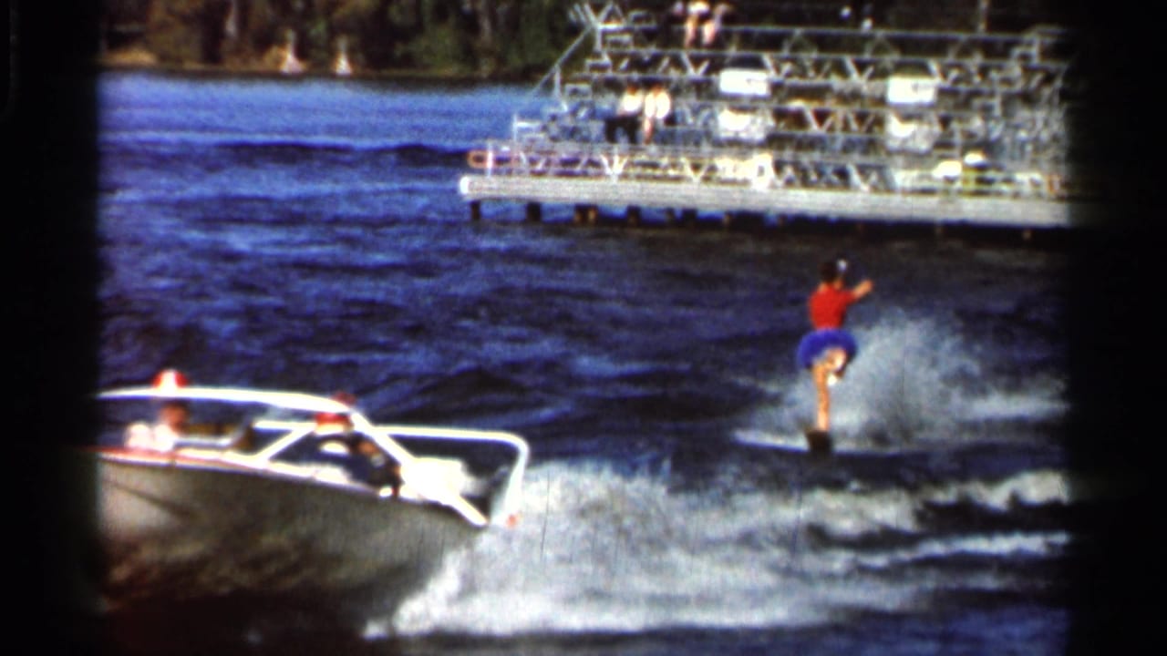A solo performer balances on one ski near a motorboat during a 1966 Florida lake water-ski show.