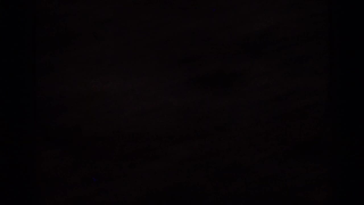 Underexposed 1966 Florida 8mm frame with a mostly dark field and faint traces of warm sunset light near the horizon.