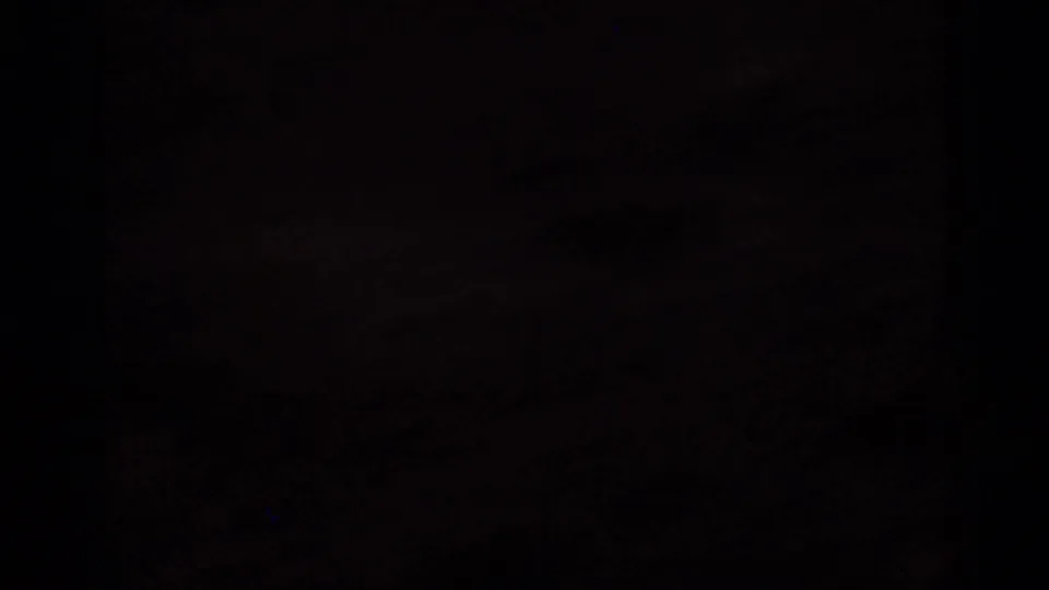 Underexposed 1966 Florida 8mm frame with a mostly dark field and faint traces of warm sunset light near the horizon.