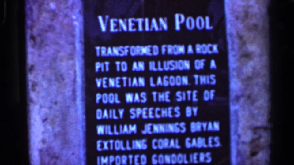 1966 Florida 8mm frame showing a Venetian Pool sign with explanatory text, partly cropped by the home-movie framing.