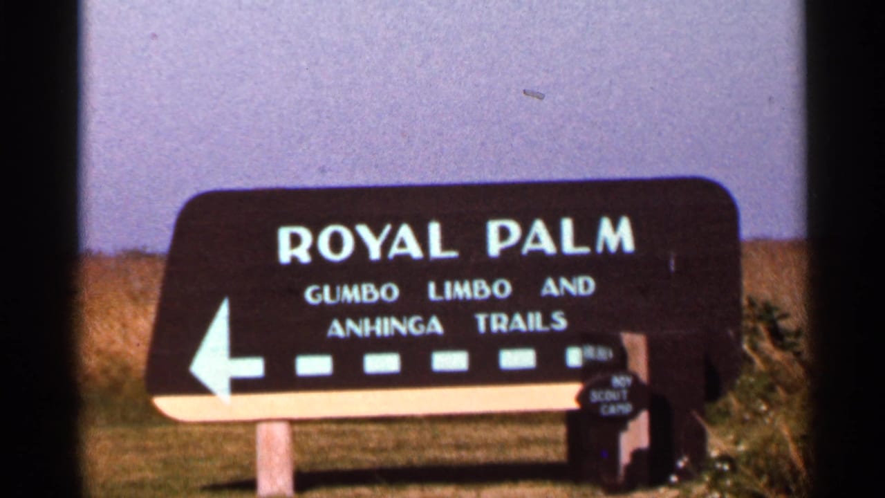 Royal Palm trail sign with trail names and a left-pointing arrow.