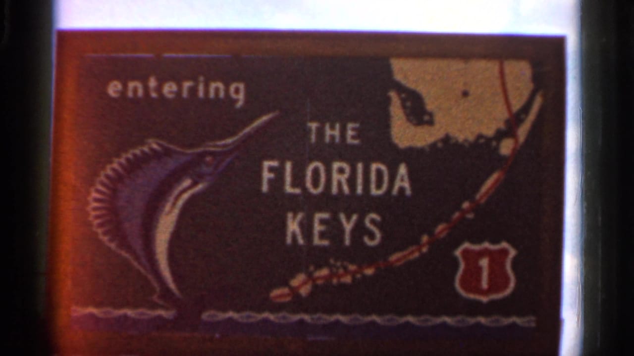 1966 Florida frame showing an entering THE FLORIDA KEYS sign with marlin graphic and Route 1 emblem.
