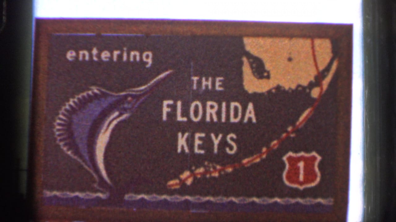 Close view of a sign reading entering the Florida Keys with marlin artwork and Route 1 emblem.