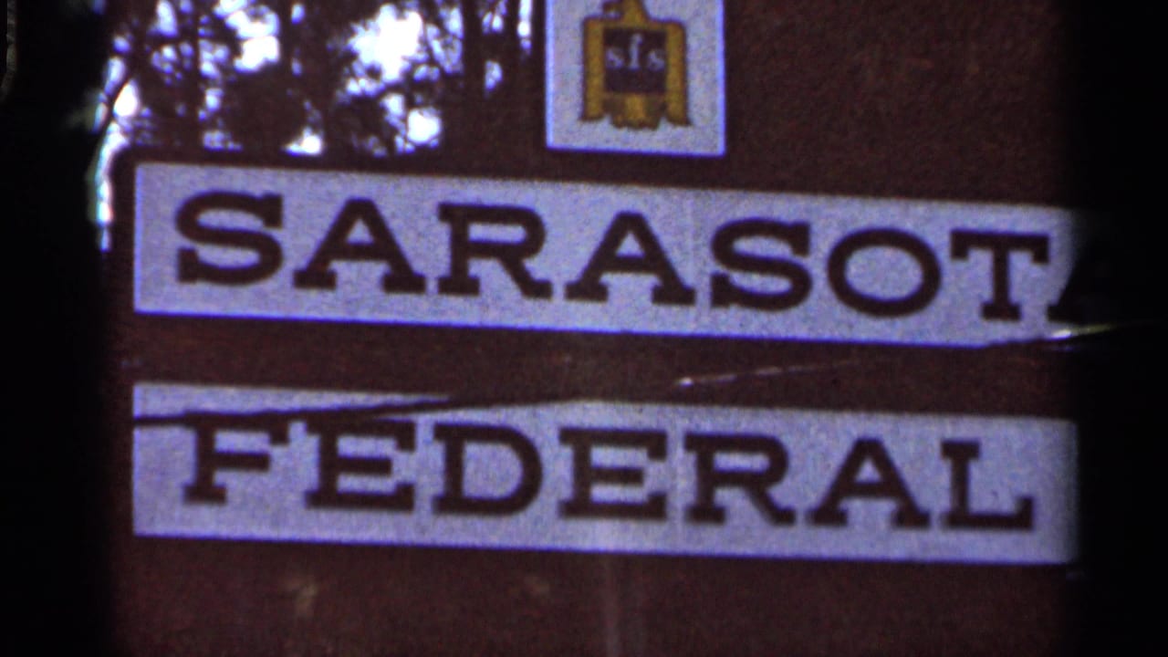 Close view of a sign reading Sarasota Federal with a small SFS logo above.